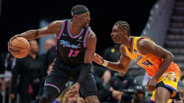 Moussa Diabate #14 of the Charlotte Hornets guards Bam Adebayo #13 of the Miami Heat in the first half during their game at Spectrum Center on March 6, 2026 in Charlotte, North Carolina.
